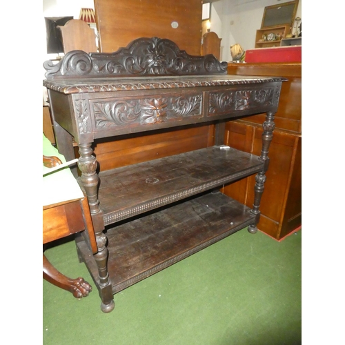 257 - A stunning antique carved oak dumb waiter with 'Green Man' design & mask handle drawers.