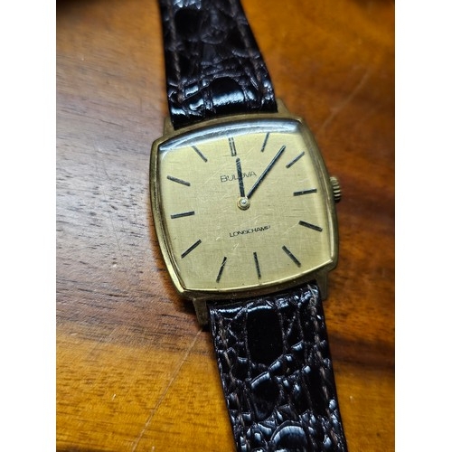 217 - A vintage Gents Bulova Longchamp wristwatch on black leather strap.