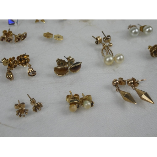 10 - An assortment of yellow metal earrings.