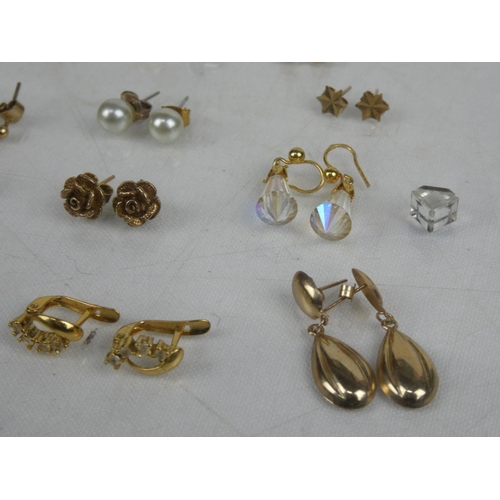 10 - An assortment of yellow metal earrings.