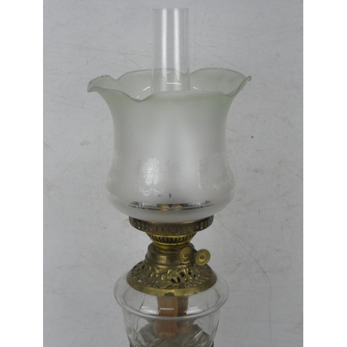 33 - An antique oil lamp with diamond cut font.