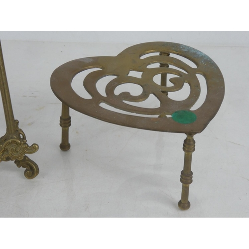 69 - A heart shaped brass trivet and a brass picture stand.