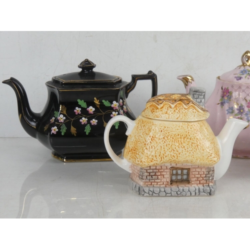 70 - A vintage Sadler floral patterned teapot with gilt detail and three others.