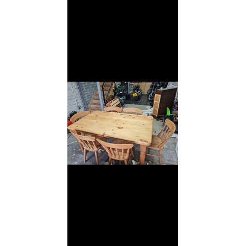 142 - A pine farmhouse table and six chairs.