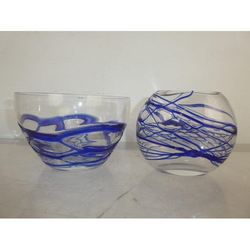 17 - A glass vase and bowl with decorative blue design.