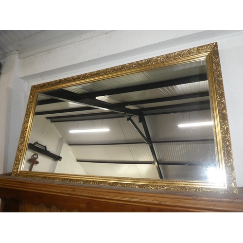 83 - A gilt framed wall mirror, measuring 51