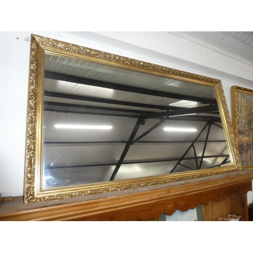 83 - A gilt framed wall mirror, measuring 51