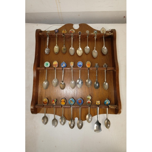 312 - Two wooden spoon racks and a lot of of souvenir spoons.