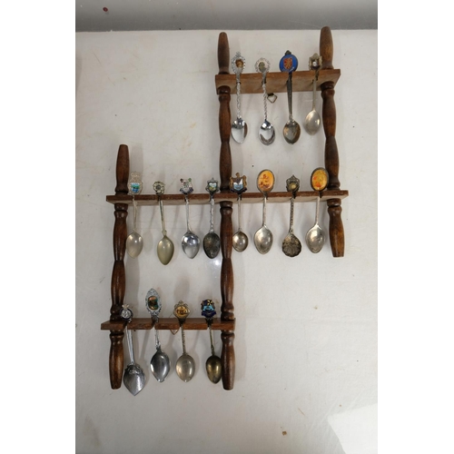 312 - Two wooden spoon racks and a lot of of souvenir spoons.