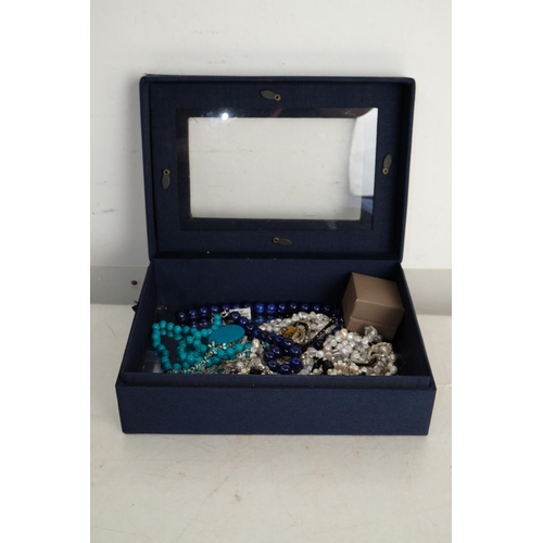 313 - A vintage jewellery box and its contents.