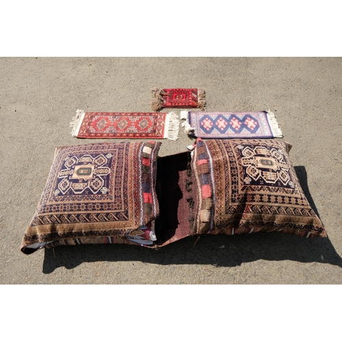 319 - Two large cushions and three prayer mats.