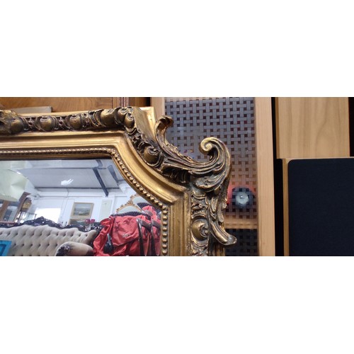 329 - A stunning large gilt framed mirror, measuring 52