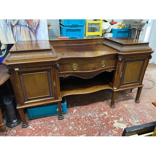 328 - A stunning Irish Georgian style mahogany sideboard on eight claw and ball feet, each foot supported ... 