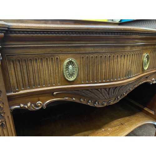 328 - A stunning Irish Georgian style mahogany sideboard on eight claw and ball feet, each foot supported ... 