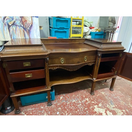 328 - A stunning Irish Georgian style mahogany sideboard on eight claw and ball feet, each foot supported ... 