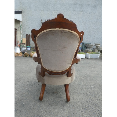 236 - An antique upholstered parlour chair with deep button backed detail.