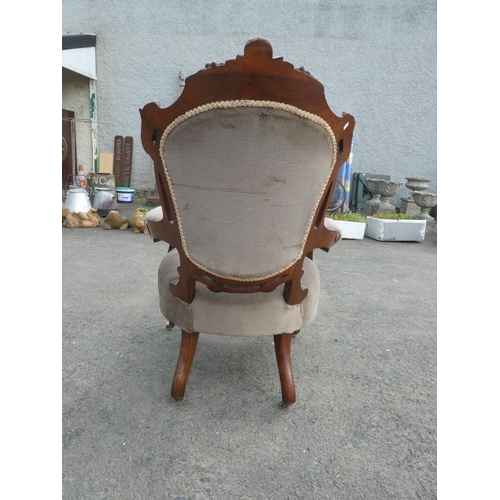 236 - An antique upholstered parlour chair with deep button backed detail.