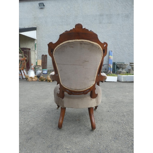 236 - An antique upholstered parlour chair with deep button backed detail.