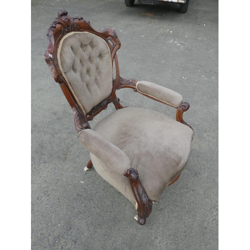 236 - An antique upholstered parlour chair with deep button backed detail.