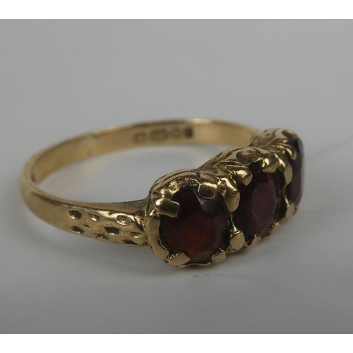 280 - A 9ct gold and three ruby stone ring.