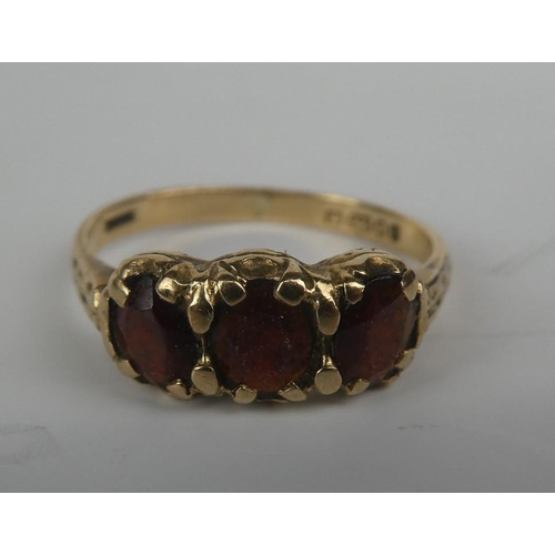 280 - A 9ct gold and three ruby stone ring.