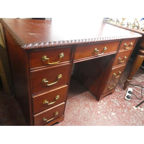 301 - A small desk with decorative edging on top.