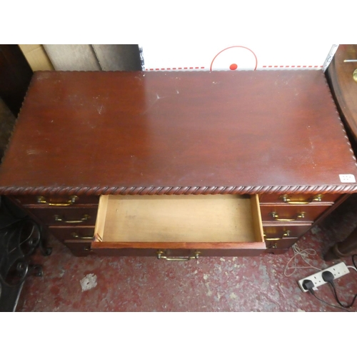 301 - A small desk with decorative edging on top.