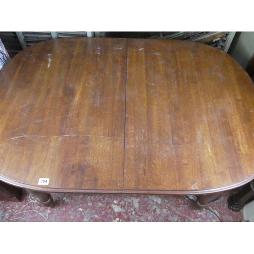 304 - A mahogany dining room table.