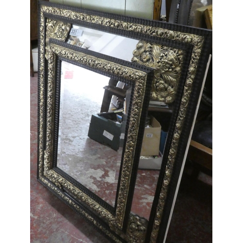 331 - A stunning French brass and ebony framed wall mirror, measuring 72cm x 84cm.