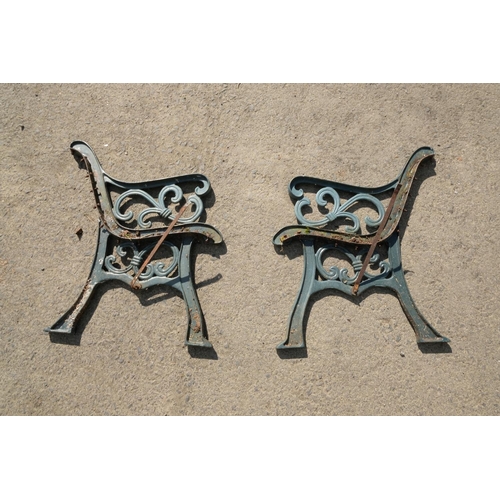 414 - A pair of metal garden bench ends.