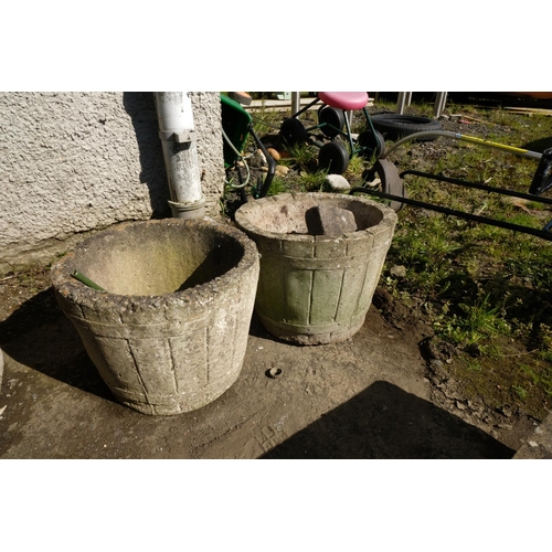 421 - A pair of concrete barrel planters.