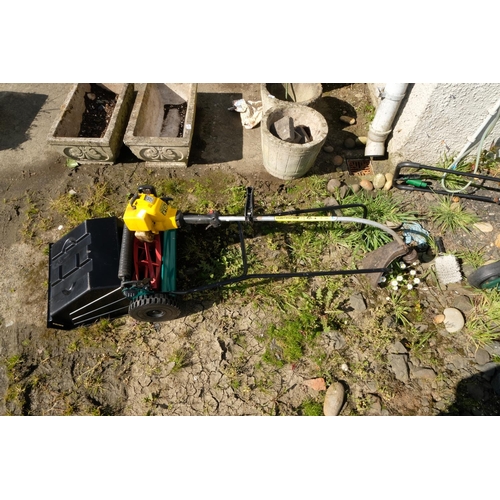 422 - A seed spreader and a McCulloch TrimMac 210 strimmer.