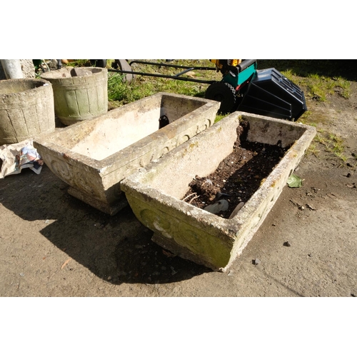 423 - A pair of long concrete planters with Art Nouveau motif.