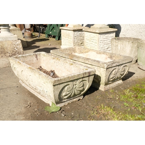 423 - A pair of long concrete planters with Art Nouveau motif.