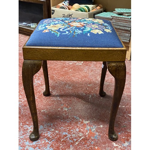 397 - An upholstered stool with tapestry panel.