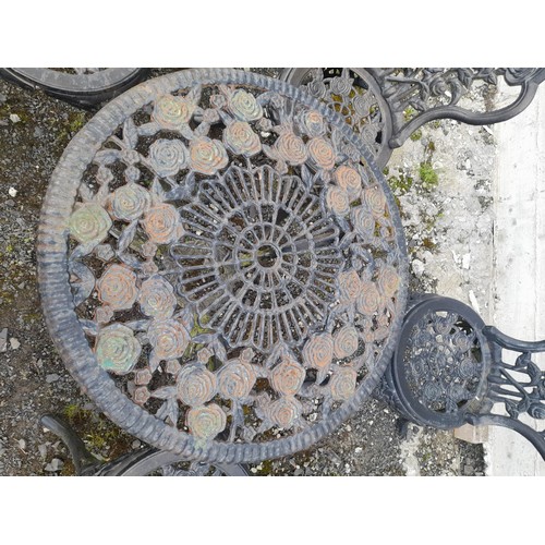 334 - A stunning cast iron garden table and four chair set with rose design.