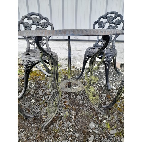 334 - A stunning cast iron garden table and four chair set with rose design.