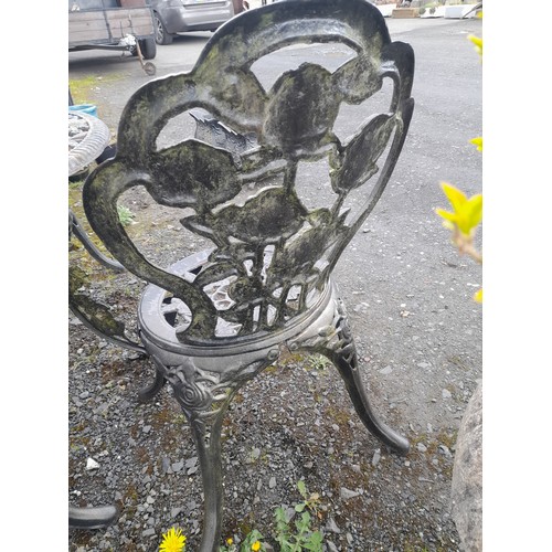 334 - A stunning cast iron garden table and four chair set with rose design.