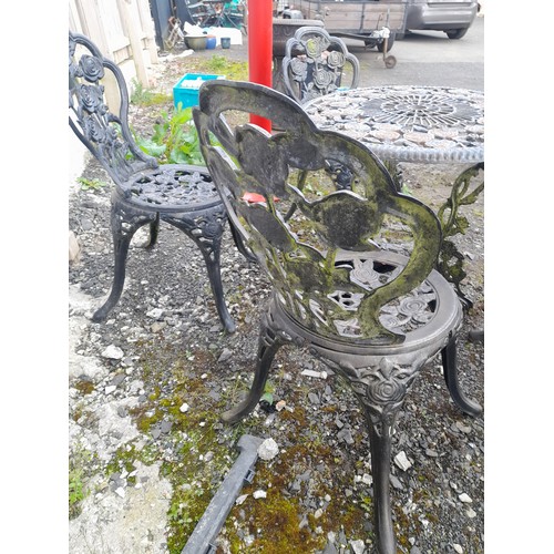 334 - A stunning cast iron garden table and four chair set with rose design.