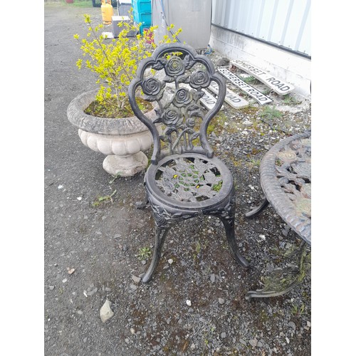 334 - A stunning cast iron garden table and four chair set with rose design.