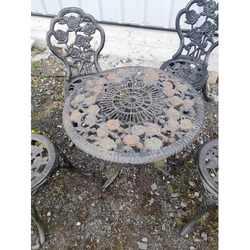 334 - A stunning cast iron garden table and four chair set with rose design.