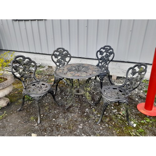 334 - A stunning cast iron garden table and four chair set with rose design.