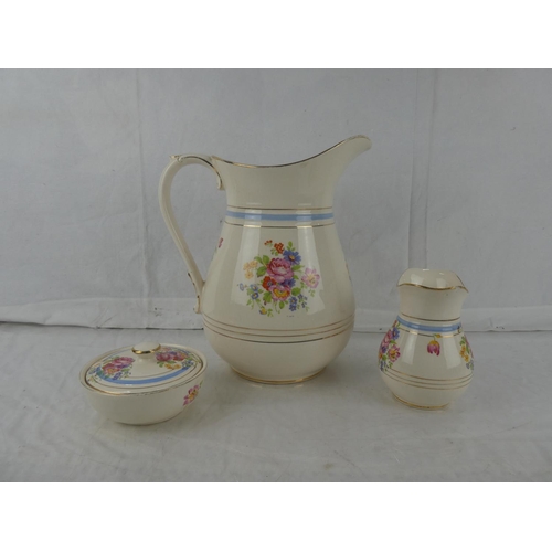 18 - A three piece Flacon Ware floral patterned wash jug set.