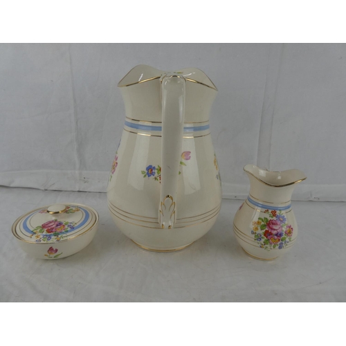 18 - A three piece Flacon Ware floral patterned wash jug set.