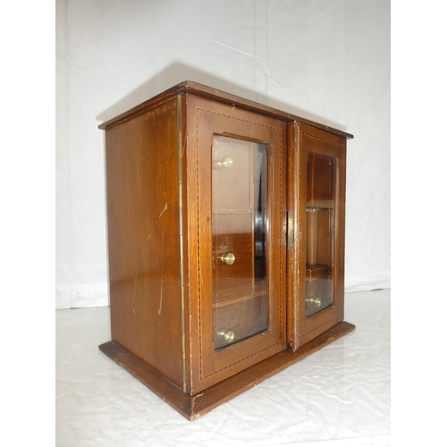 21 - An inlaid mahogany smokers cabinet, measuring 12