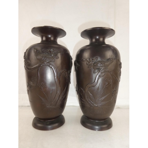 30 - A pair of antique bronze urns with Oriental design, each measuring 10