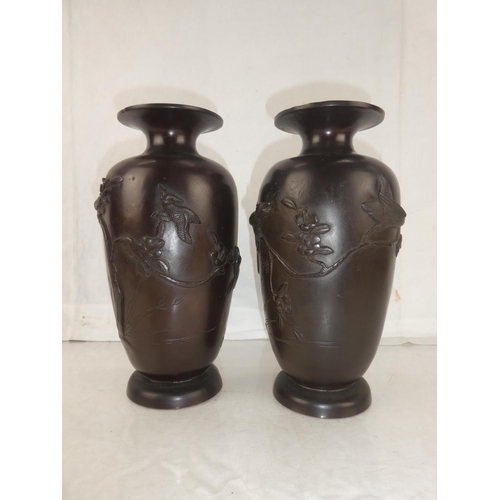 30 - A pair of antique bronze urns with Oriental design, each measuring 10