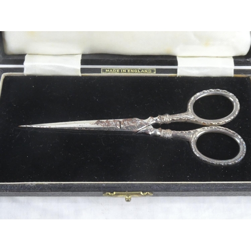 70 - A cased pair of Sterling Silver handled scissors presented to Mrs E C Stevenson by Gold Springs of C... 