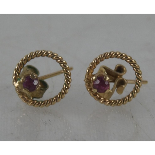 76 - A pair of 9ct gold and ruby earrings.