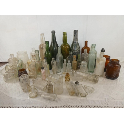 82 - A large lot of antique and vintage glass bottles.